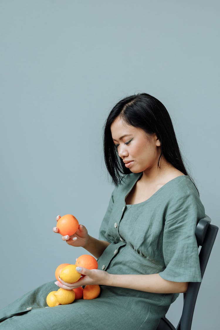 Photo Of Woman Holding Orange Fruit