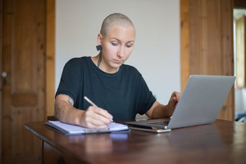 Free A Woman Writing on the Paper  Stock Photo