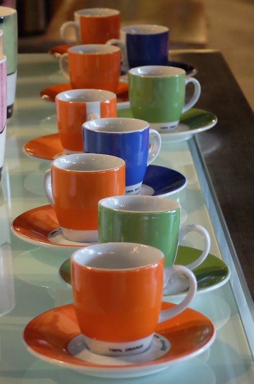 Free Colorful Cups and Saucers on the Table Stock Photo