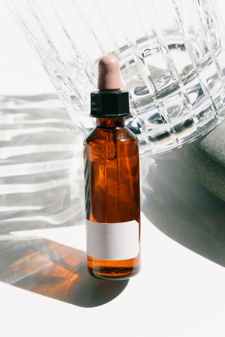 Close-up Of Cosmetic Liquid Bottle On White Background