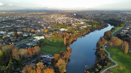 Free Aerial Shot of a River Across the City Suburbs Stock Photo