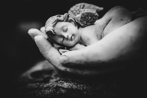 Grayscale Photo of Woman Lying on Sand