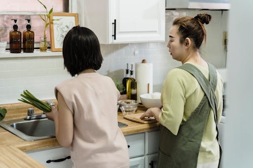 Free A Mother and daughter Preparing Food Stock Photo