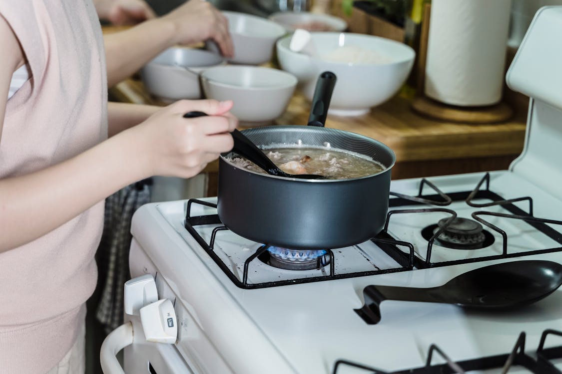 Femal Hands Cooking in Pot · Free Stock Photo
