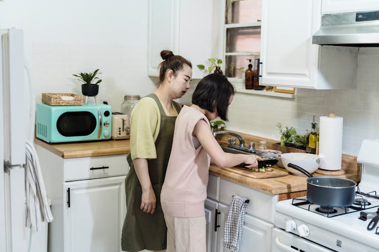 Mother And Child Cooking At The Kitchen