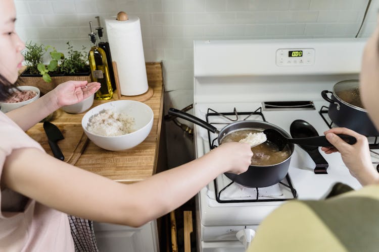 Kid Putting Rice In A Pan