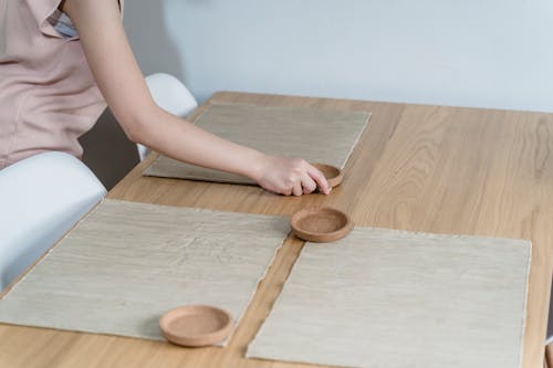 A Person Setting the Dining Table