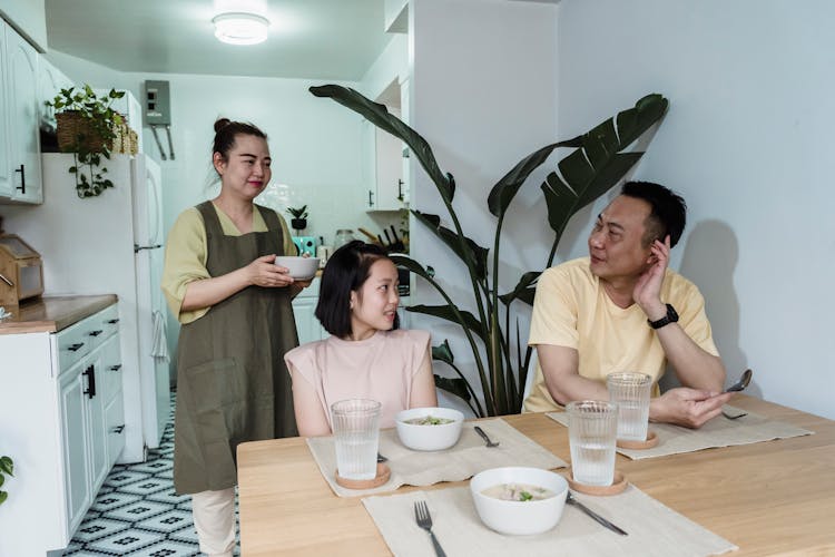 Mother Serving Food To Her Family