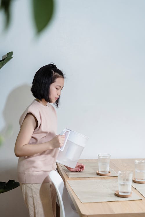 Free Kid Holding a Pitcher of Water Stock Photo
