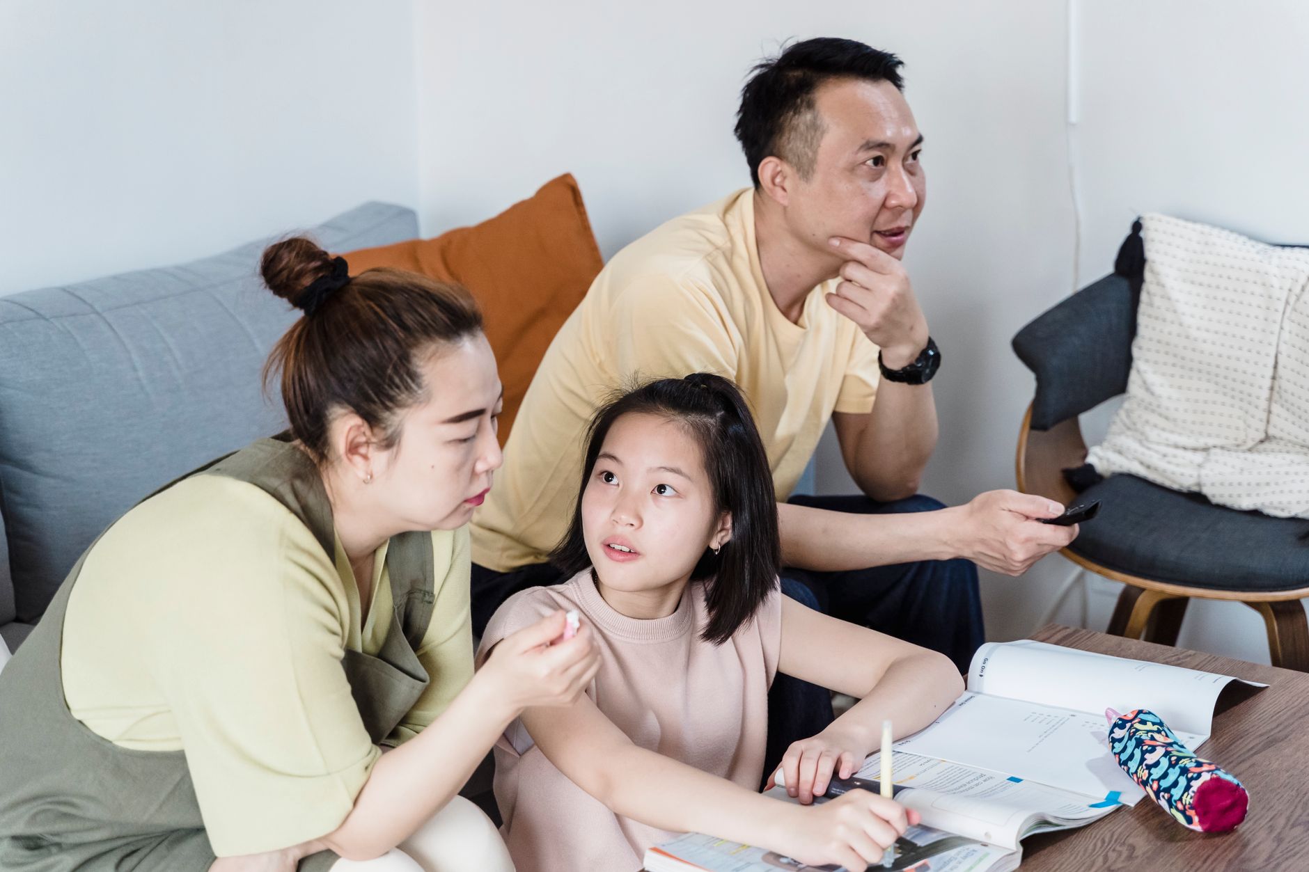 Taiwanese family reviewing monthly expenses and gambling transactions at a kitchen table