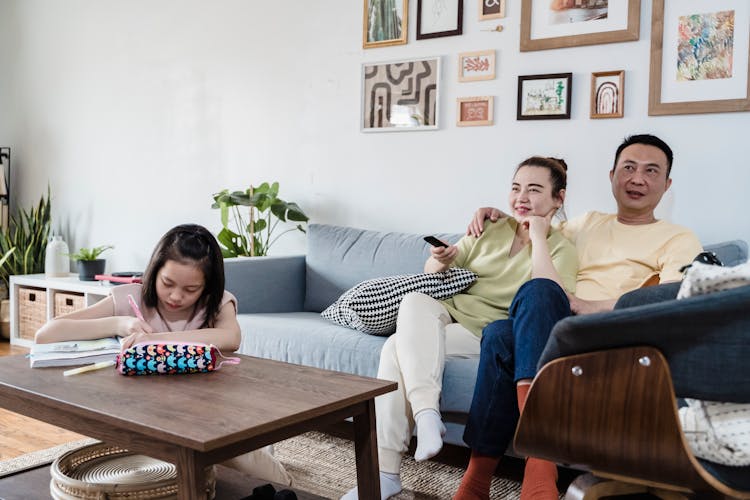 Parents Watching TV While A Girl Studying