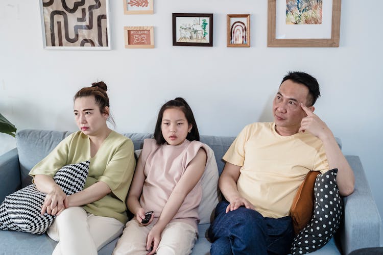 A Family Sitting On The Couch