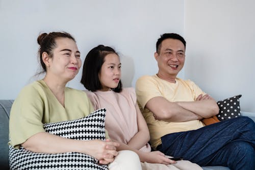 Free Family Sitting Together on a Sofa Stock Photo