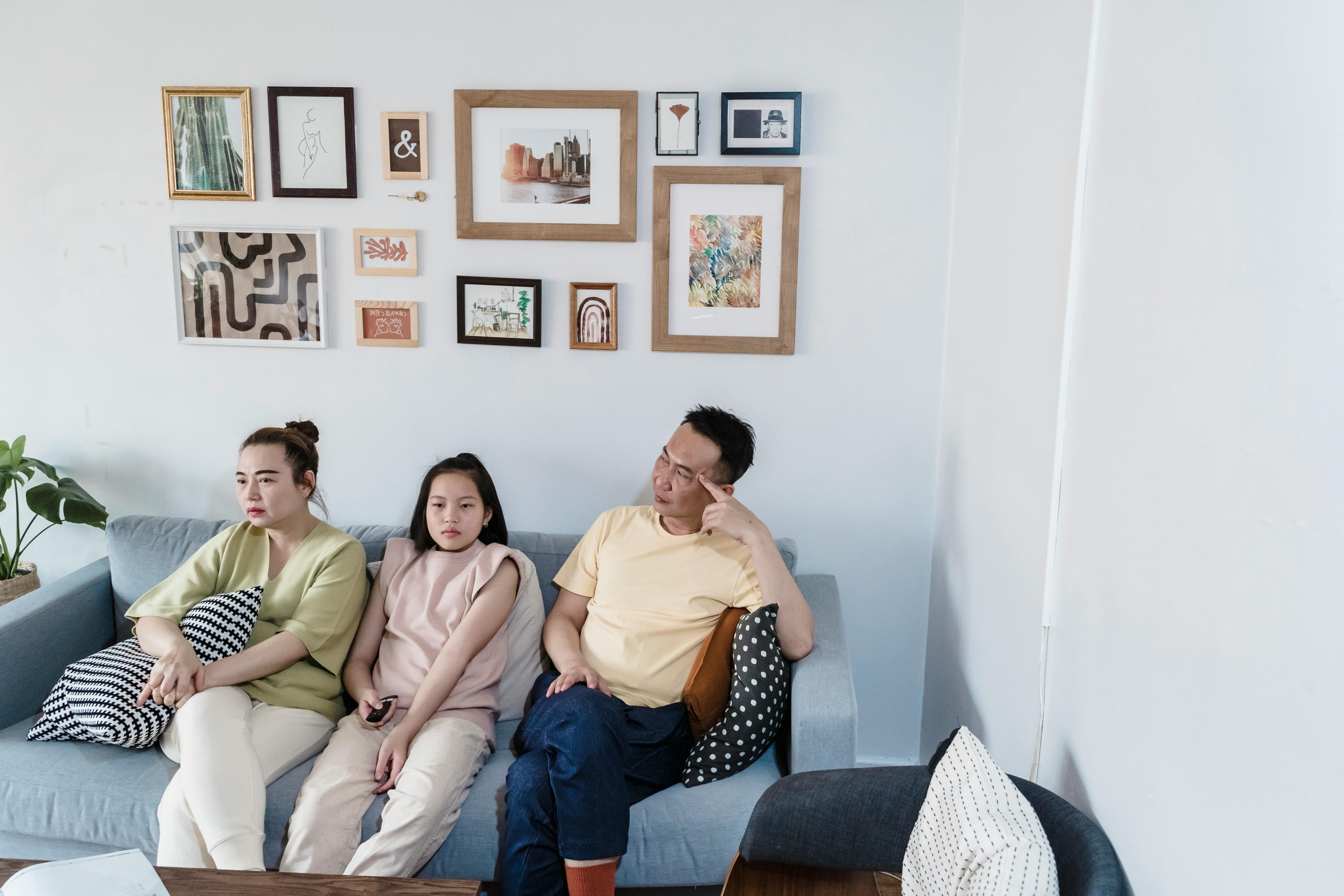 A Family Sitting On The Couch Free Stock Photo   Pexels Photo 8055089 