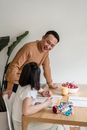 A Man Helping his Daughter with her Homework