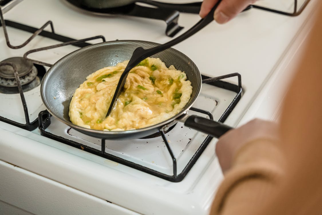 Free A Person Cooking Scrambled Eggs Stock Photo