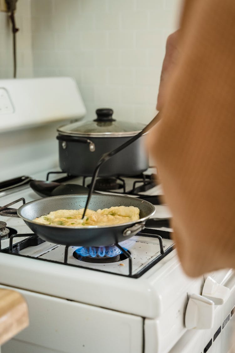 A Person Cooking Scrambled Eggs