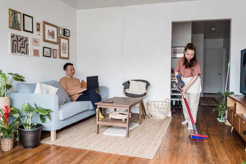 Cleaner vacuuming a living room