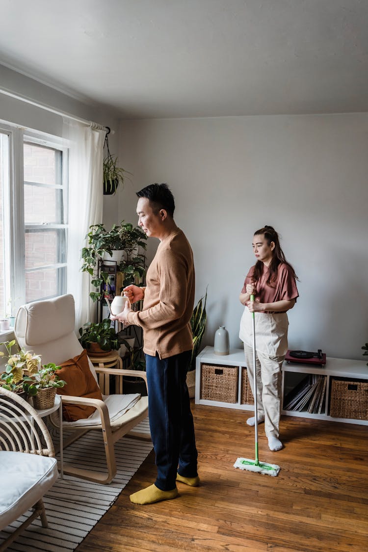 A Couple Cleaning The Living Room