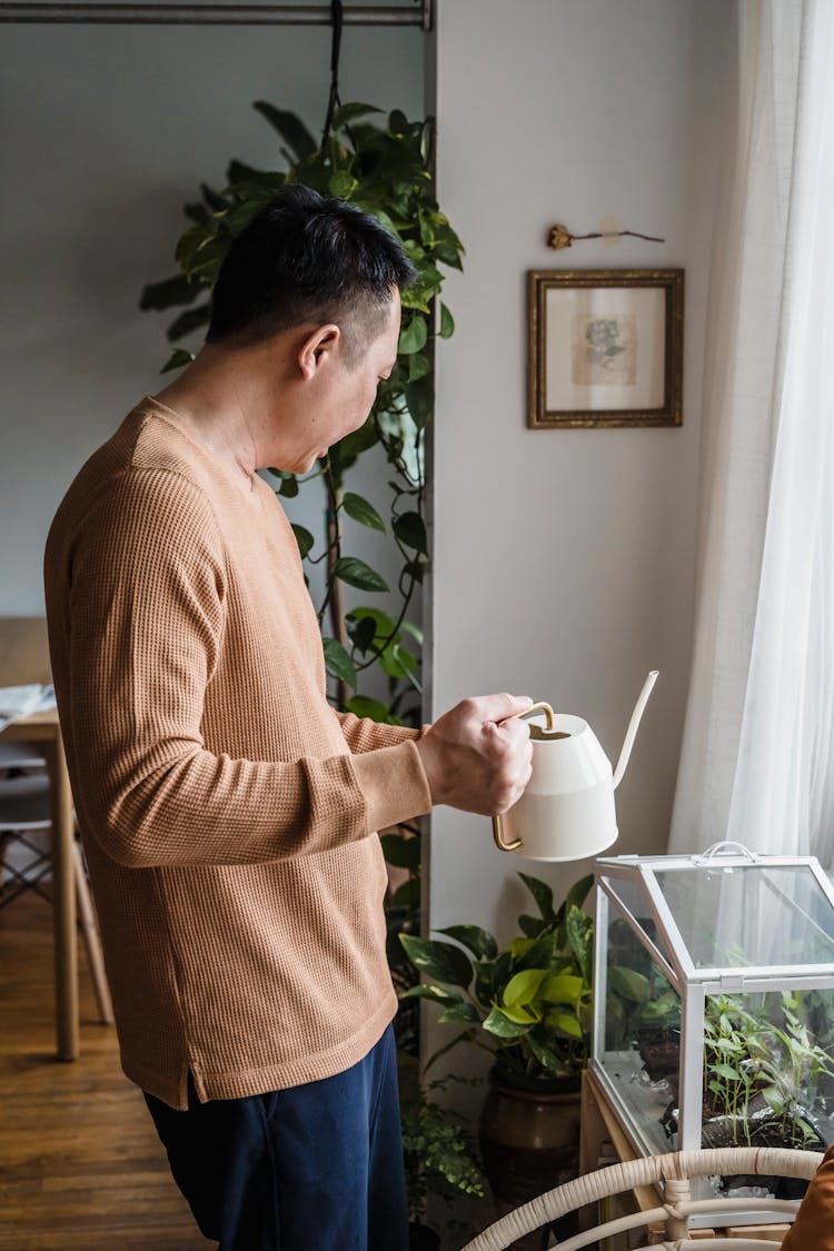 A Man Holding A Kettle