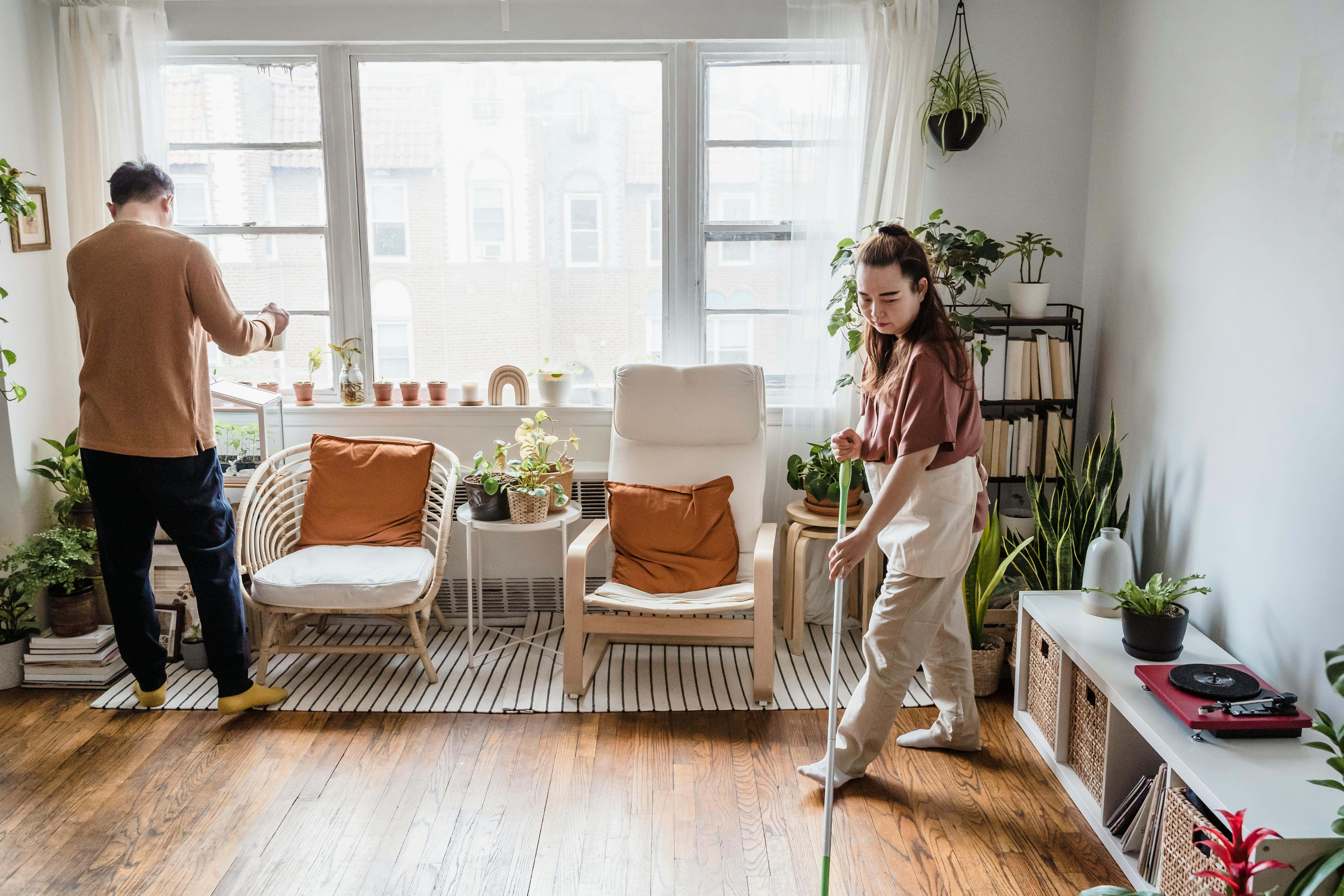 a man and a woman cleaning their house