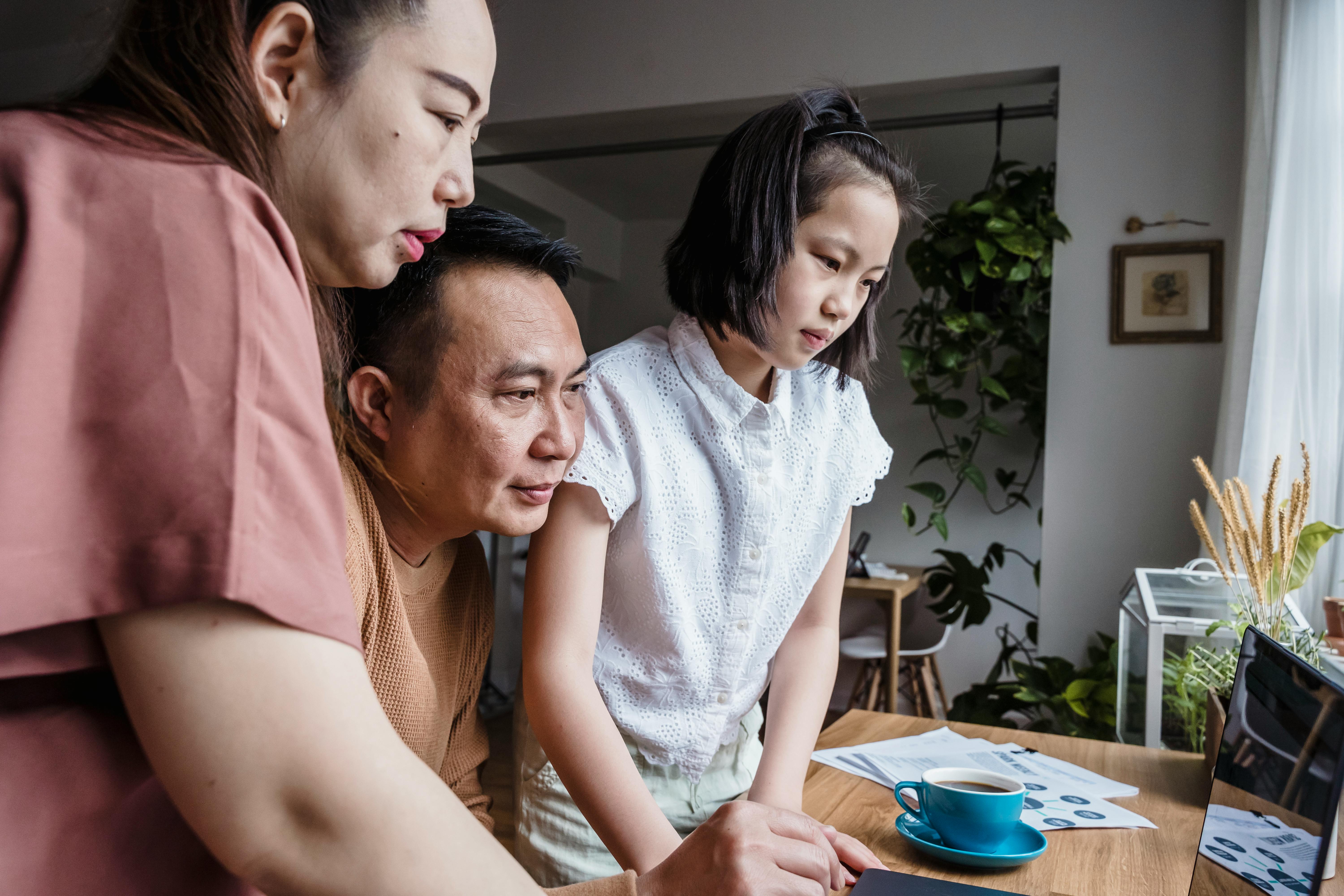 young family looking at laptop - most affordable term life insurance
