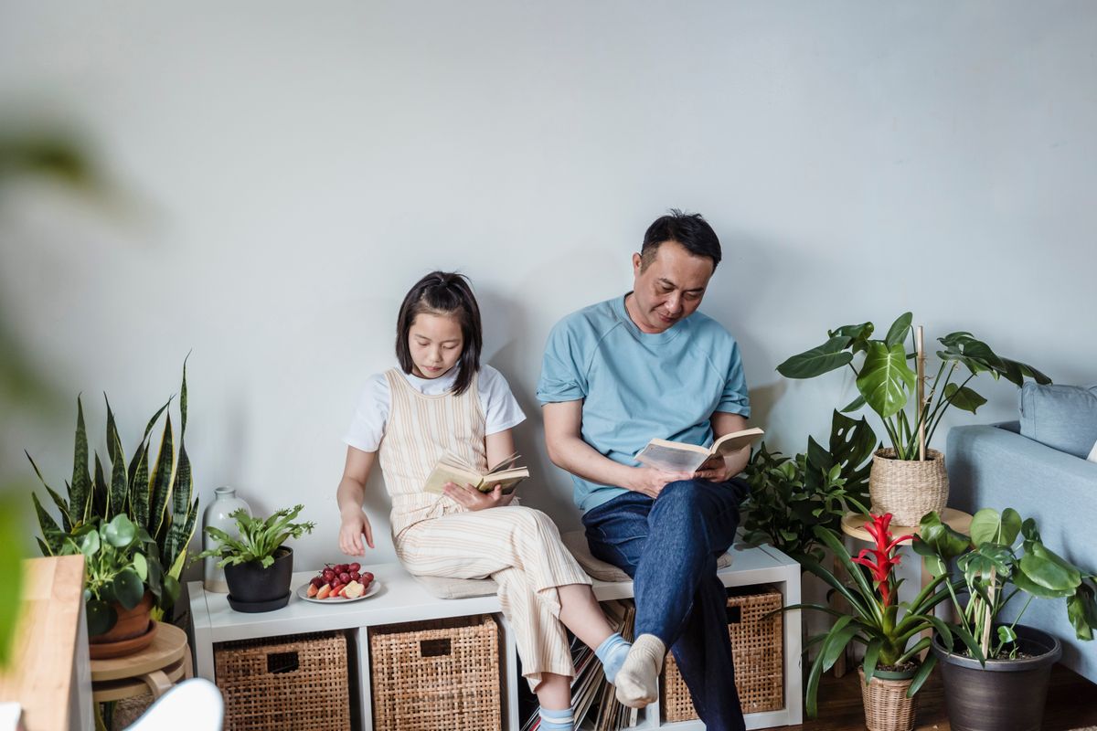 Parent and child reading together at home