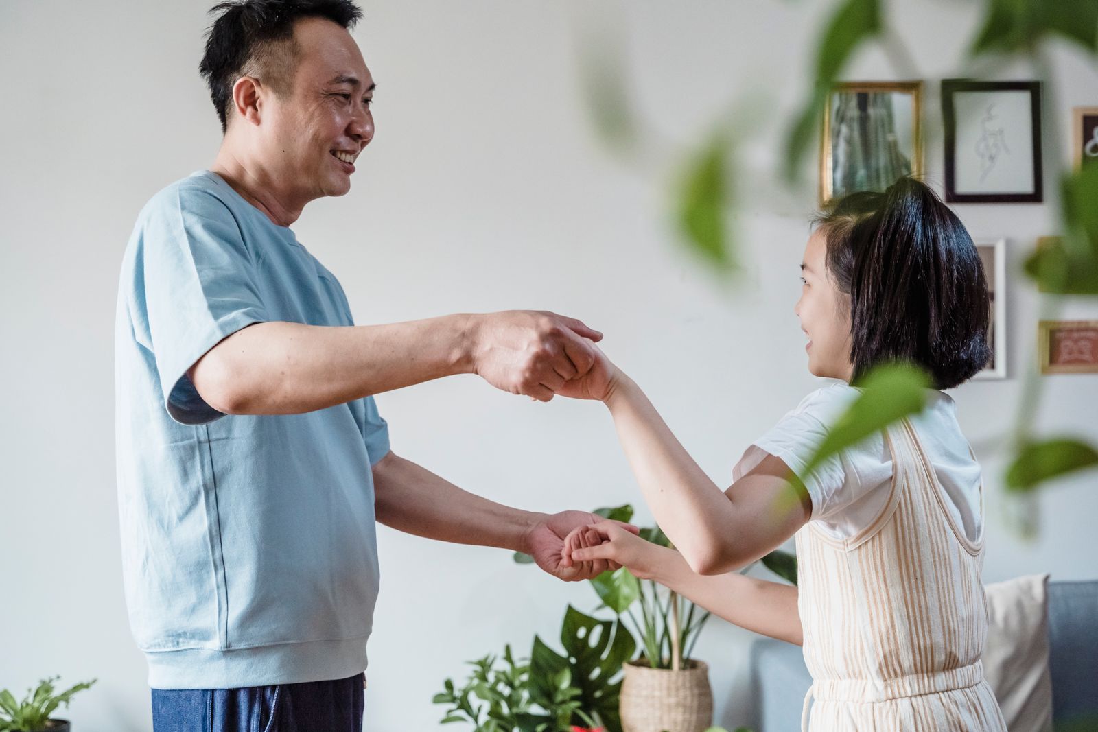 Family dancing and having fun together in a home workout session