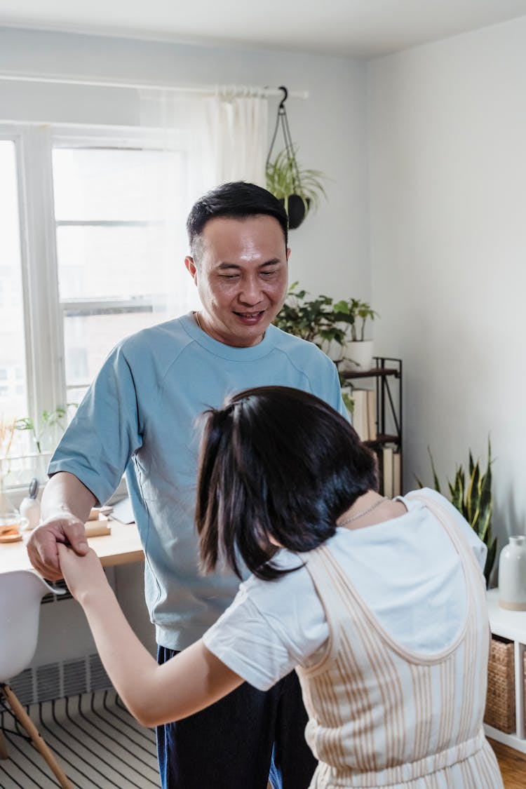 Father And Daughter Dancing Together