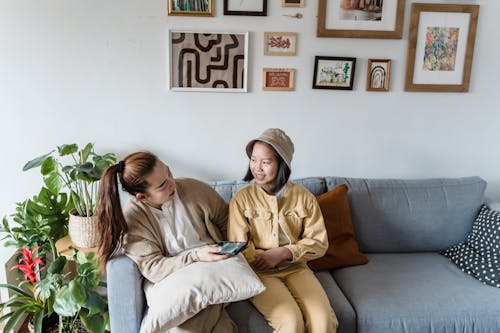 Girl Sitting on Sofa with Mother