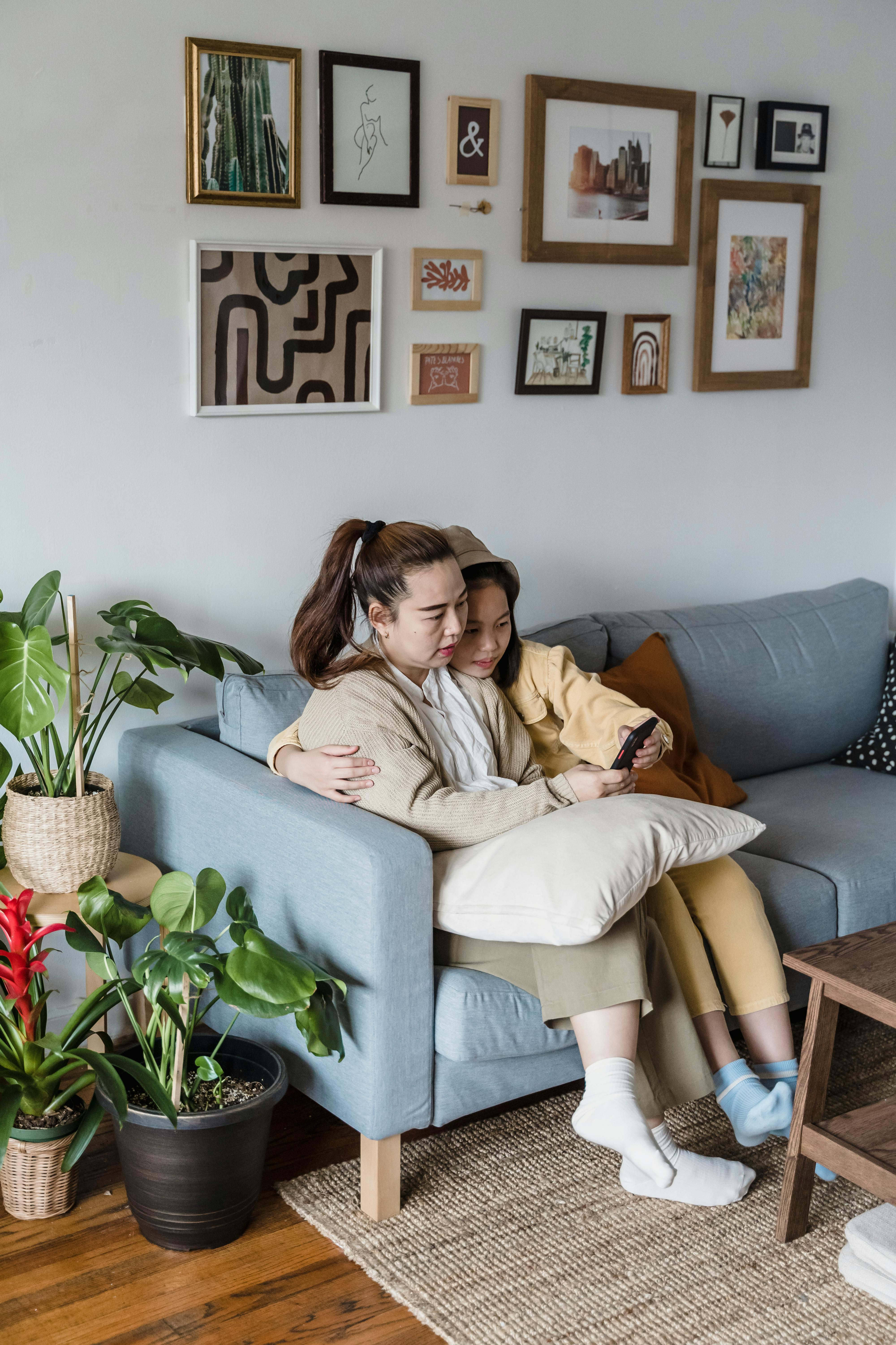 mother and daughter sitting on the couch