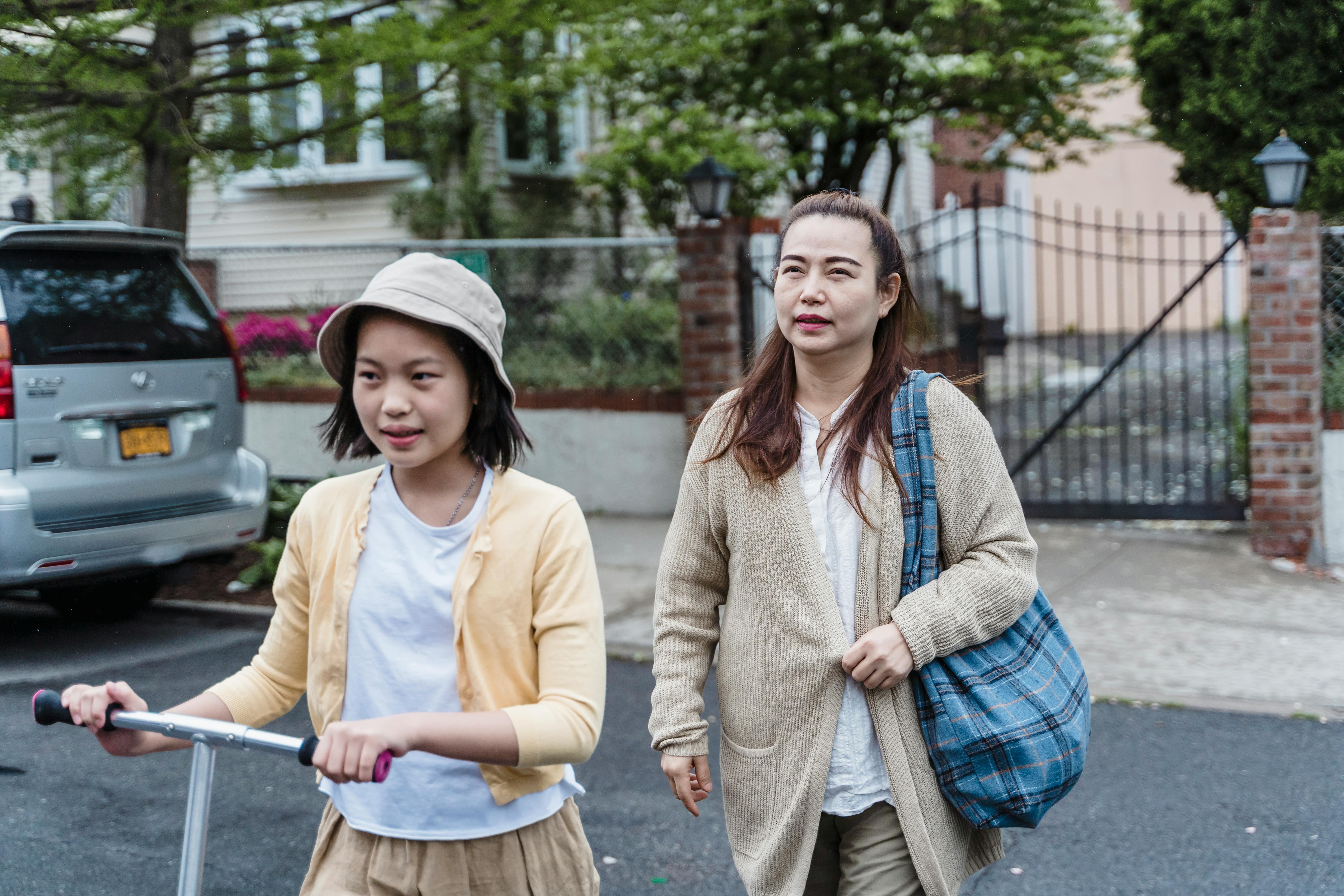 mother and daughter crossing the street