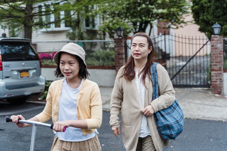 Mother And Daughter Crossing The Street