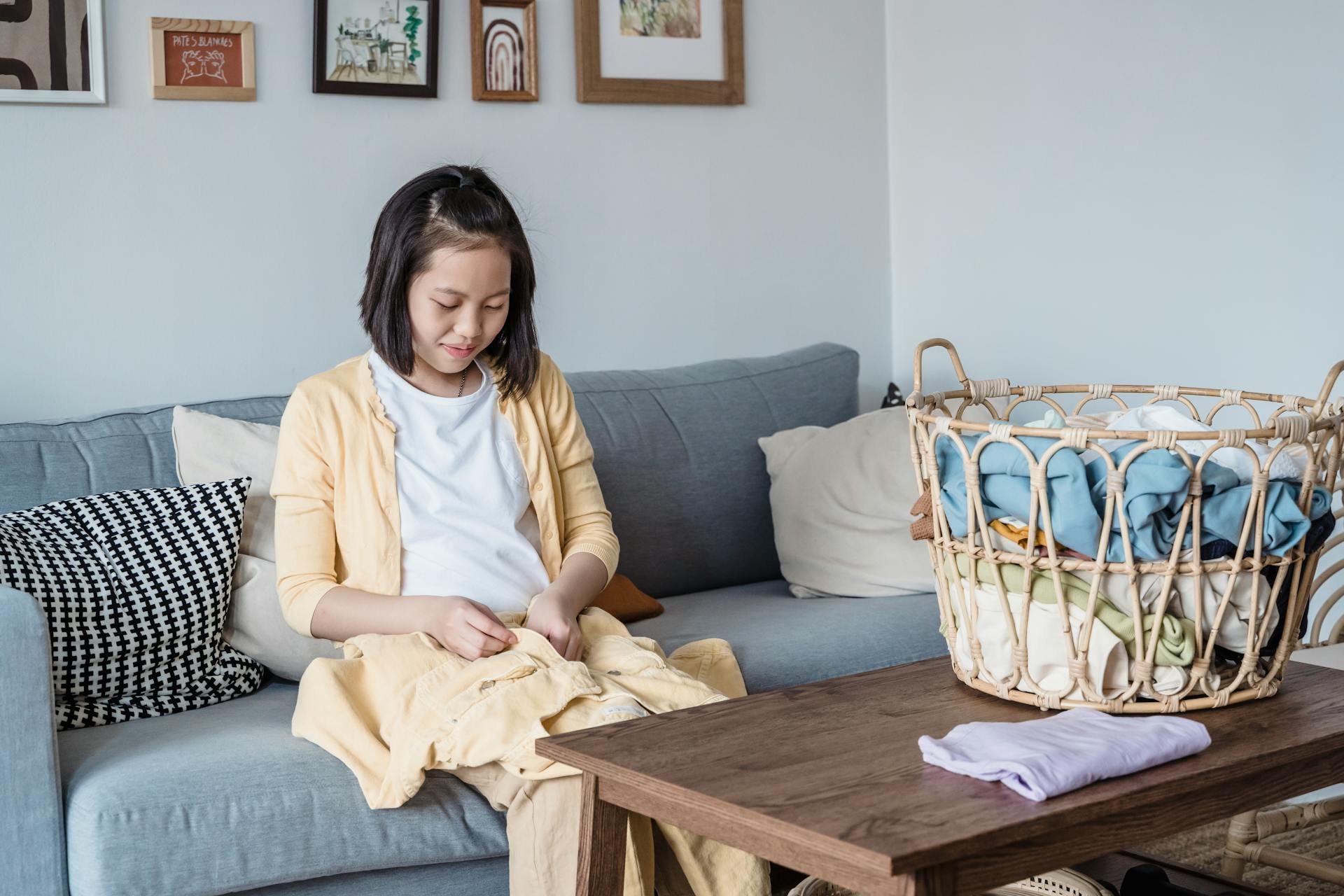 Adolescent Female folding Laundries