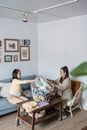 Woman in Brown Long Sleeve Shirt Sitting on Couch