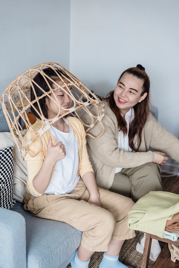 Woman And A Kid Playing With A Laundry Basket