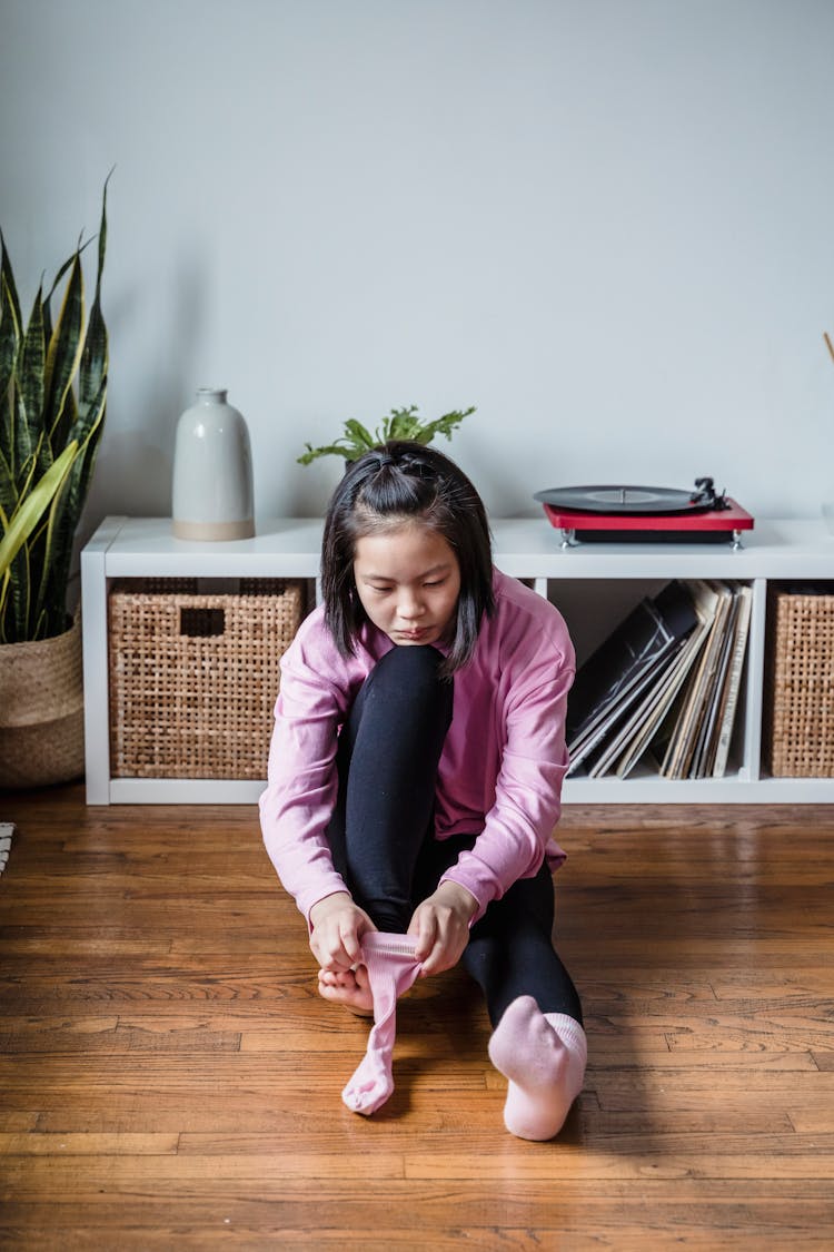 Young Girl Putting On A Sock