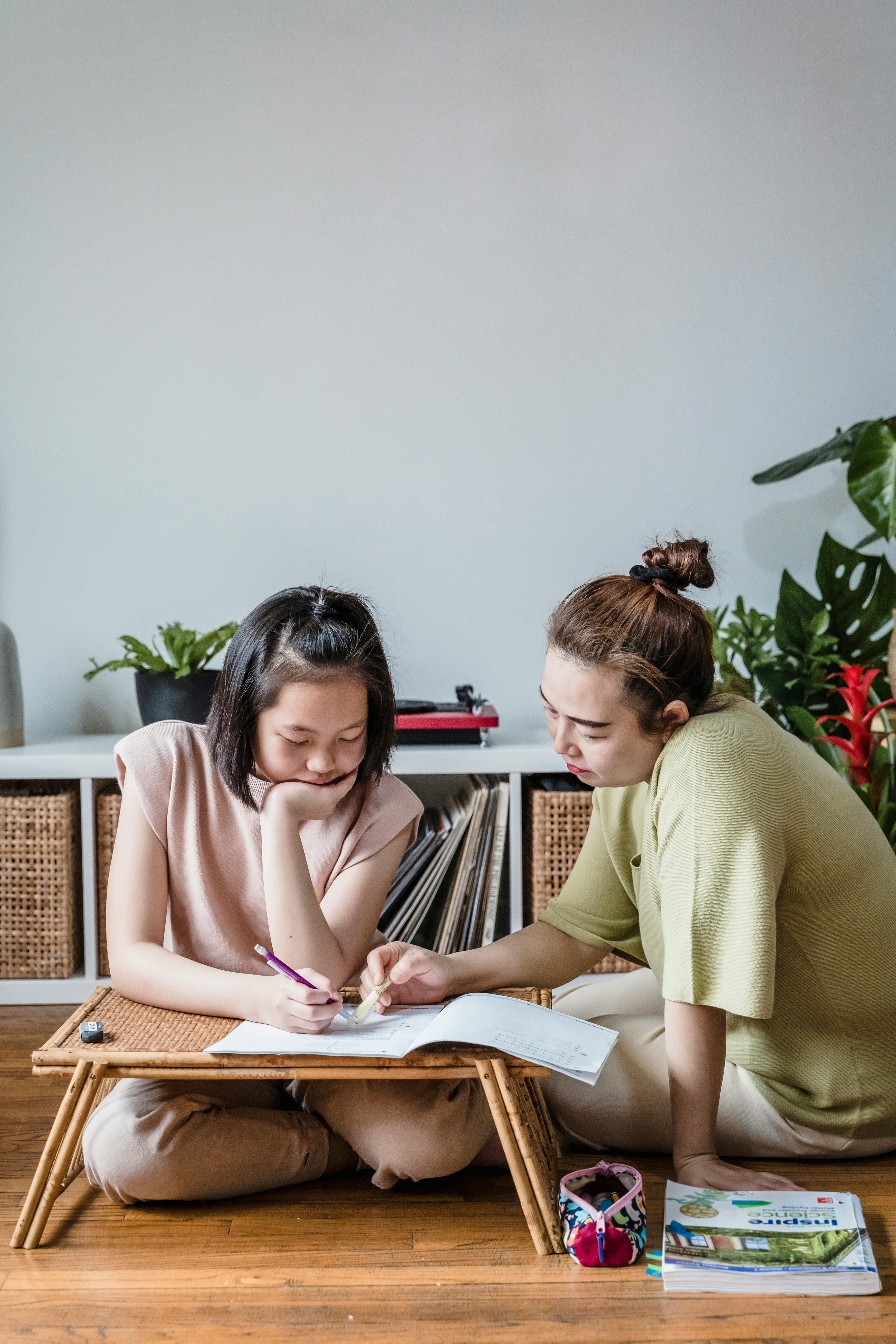 mother helping her daughter on her studies