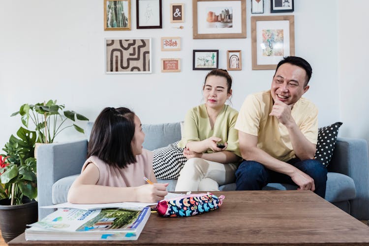 Girl Doing Her Homework With Parents