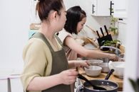 Mother and Daughter preparing Food in the Kitchen