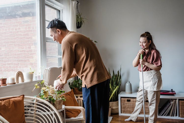 A Couple Sharing House Chores At Home