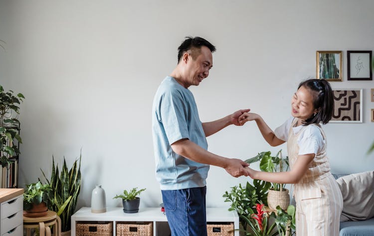 Father And Daughter Dancing Together