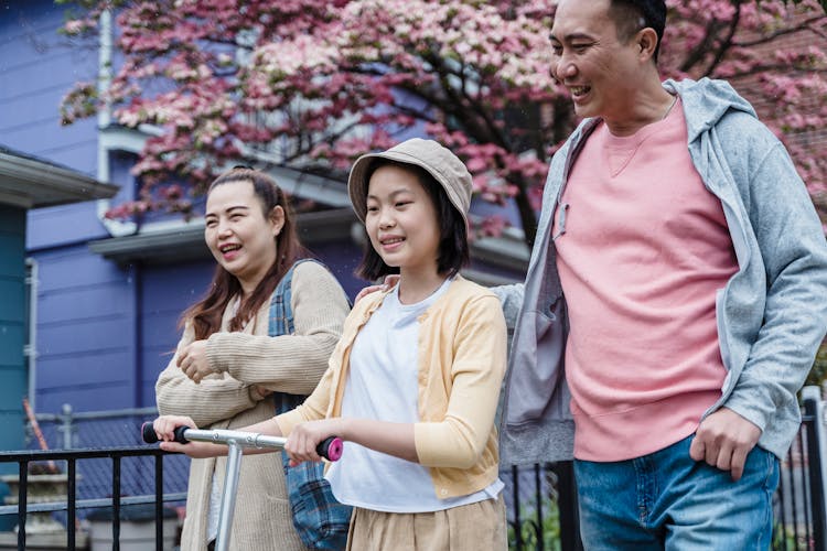 A Family Walking On The Street