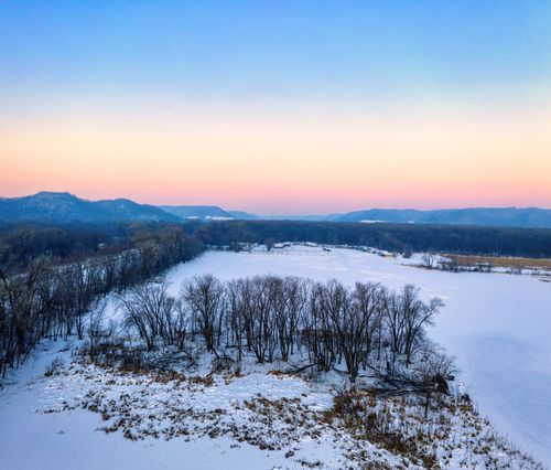 Free A breathtaking aerial view of a frozen lake and snowy landscape in Winona, Minnesota at sunset. Stock Photo