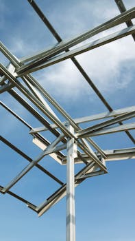A structural steel framework set against a clear blue sky.