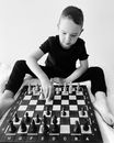 Boy Playing Chess on Table
