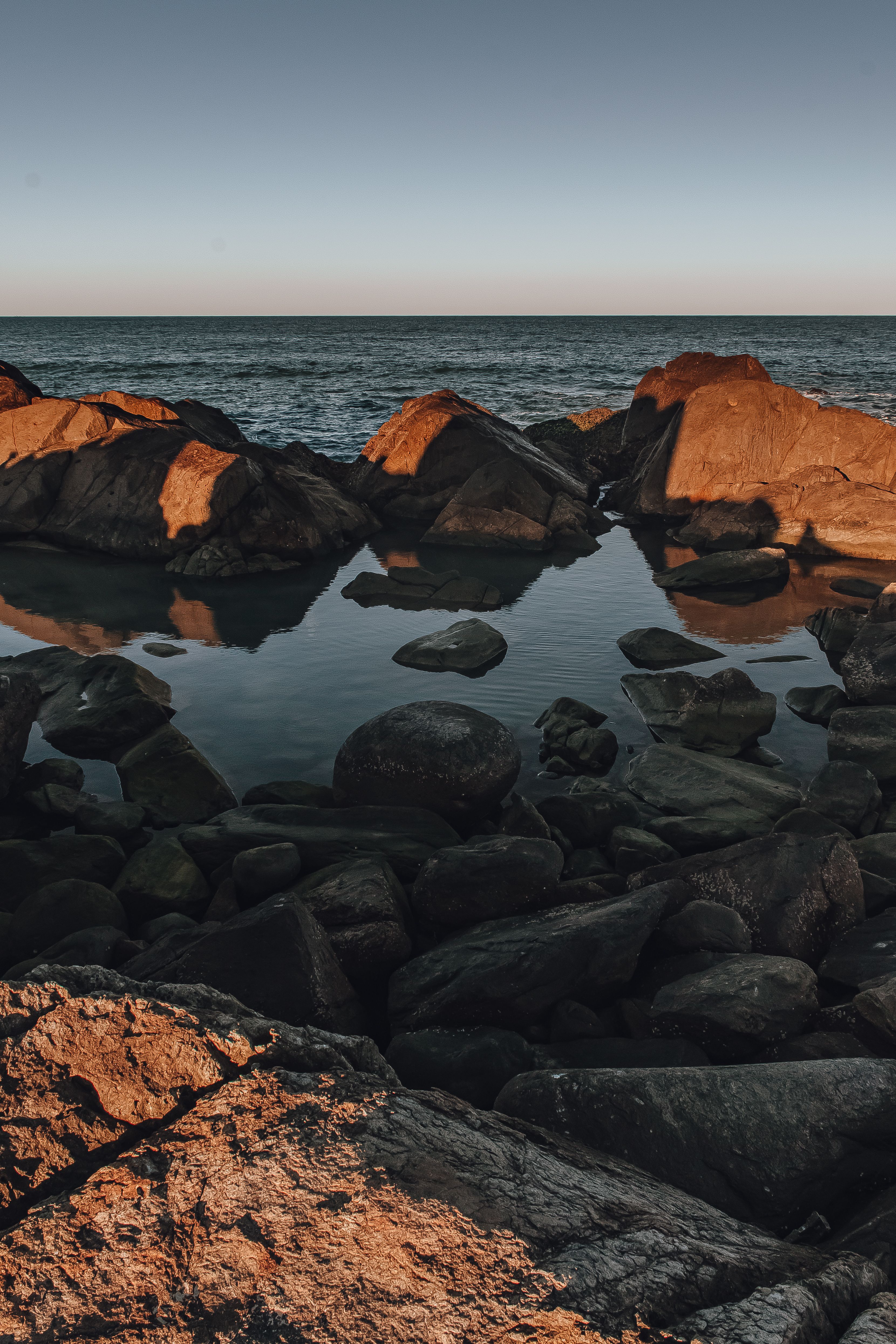 Brown Rocks on Body of Water · Free Stock Photo