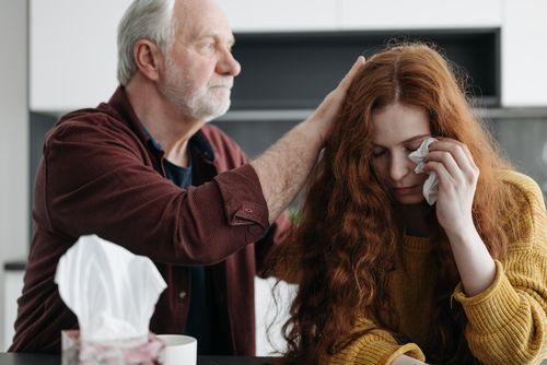 Free A father consoles his distressed daughter indoors, showcasing love and support. Stock Photo