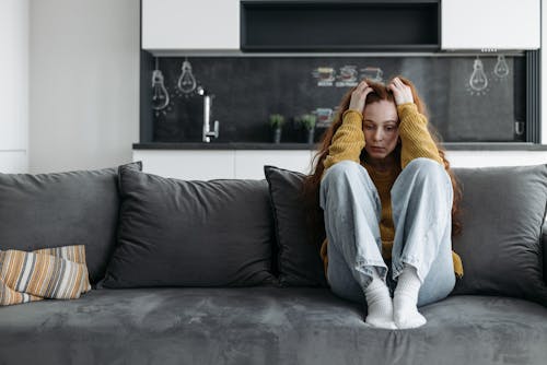 Free Woman in Sitting on a Couch Stock Photo