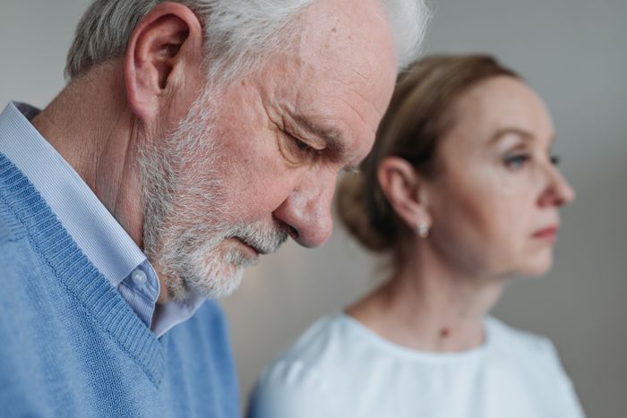 Mature couple sitting quietly, feeling emotionally distant